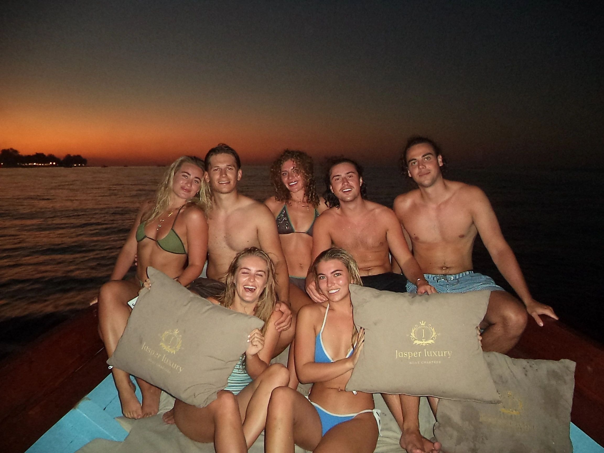 Group of guests on the beach with Jasper Luxury towels at sunset
