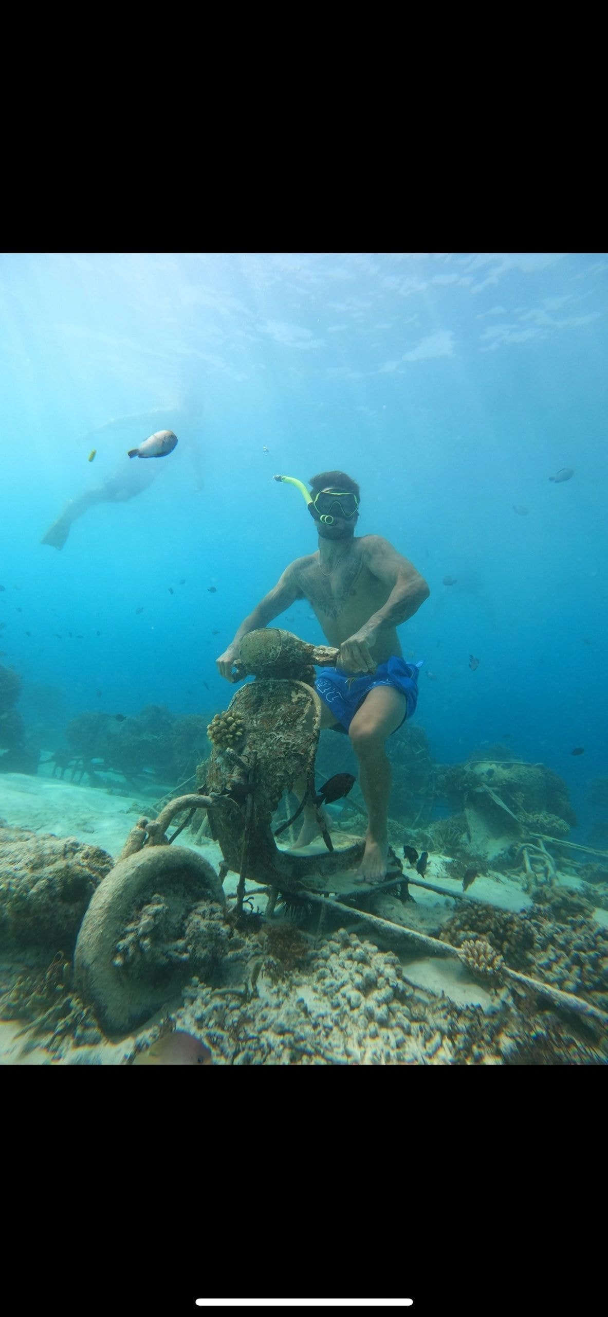 Snorkeler exploring underwater statues