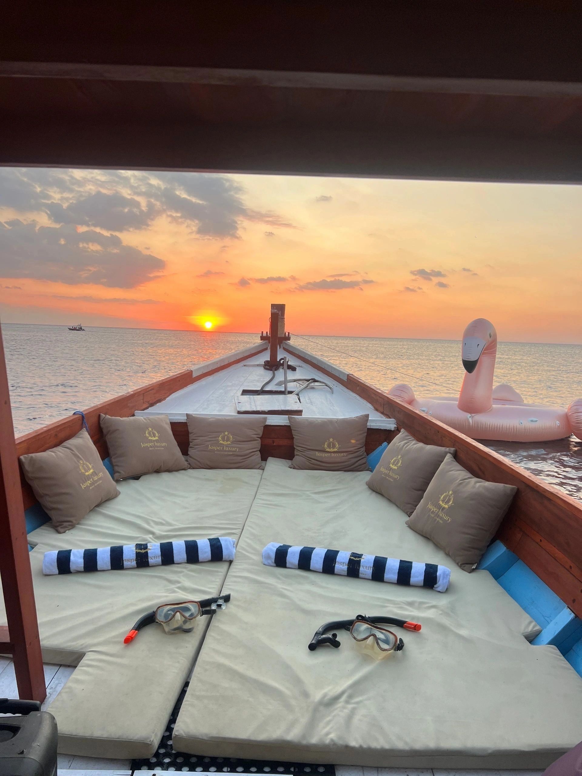 Sunset seascape with traditional boat silhouette
